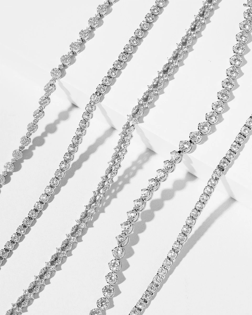 Diamond bracelets arranged diagonally on a white display