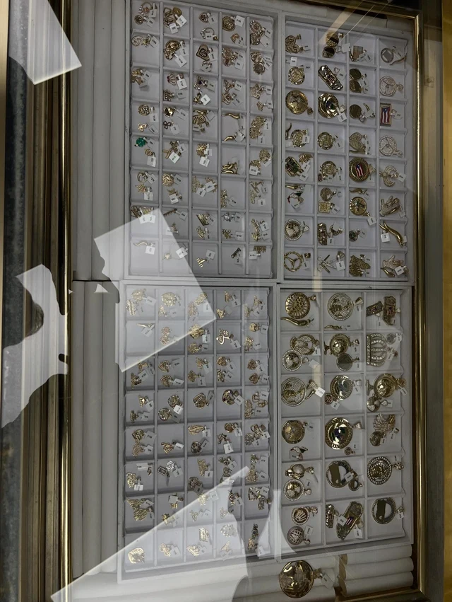 Gold charms and earrings on display